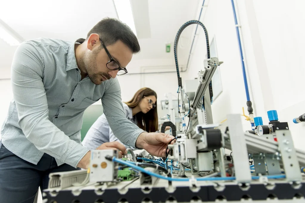 People work in an electronics lab